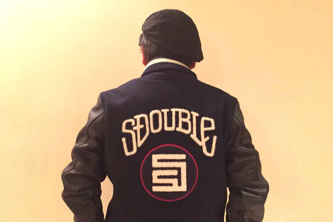 Shawn Stussy's S/DOUBLE x BEAMS black varsity jacket collab seen from the back